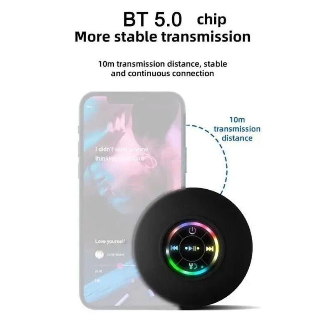 Bluetooth shower speaker attached to glass surface in bathroom