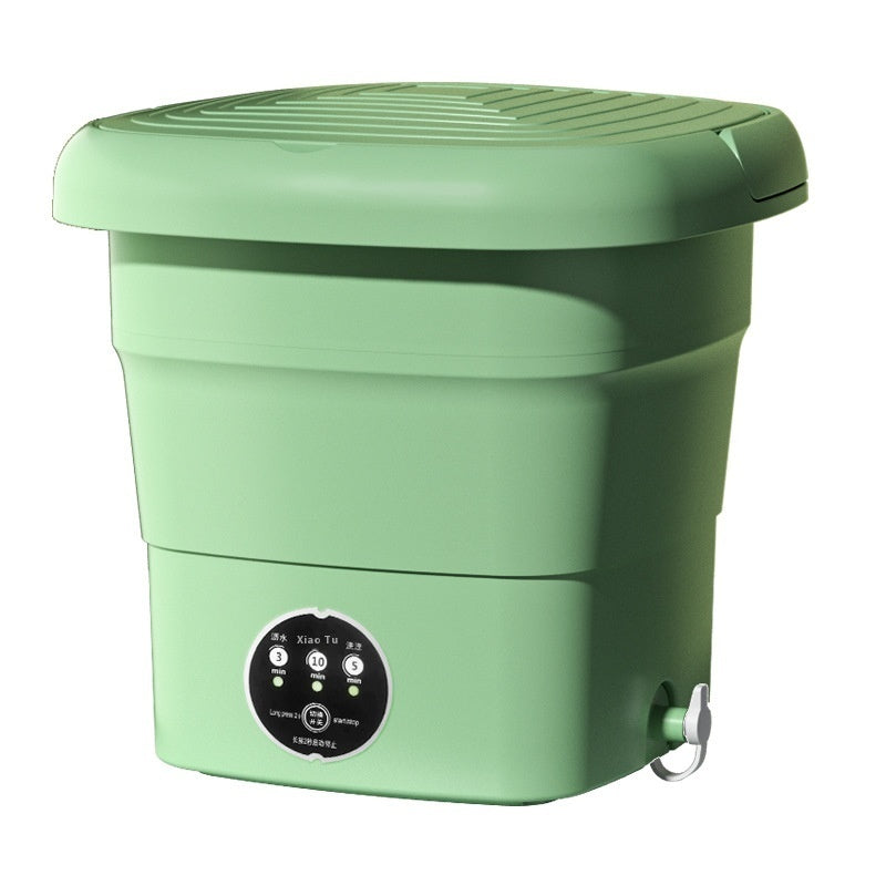 Close-up of the mini washer's drain basket and control area