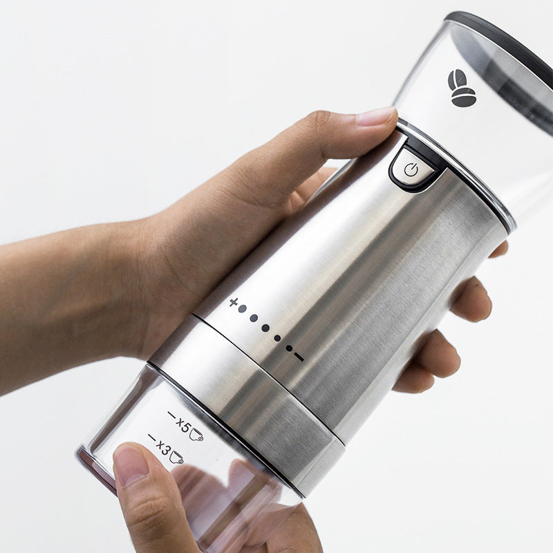 Compact stainless steel coffee grinder on a countertop