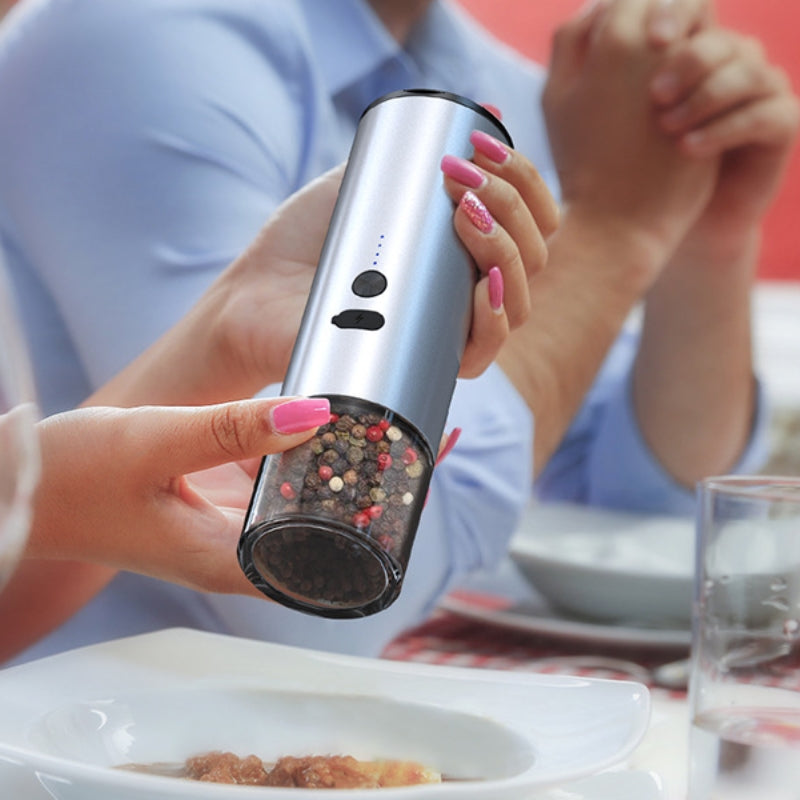 Electric grinder being used one-handed while cooking