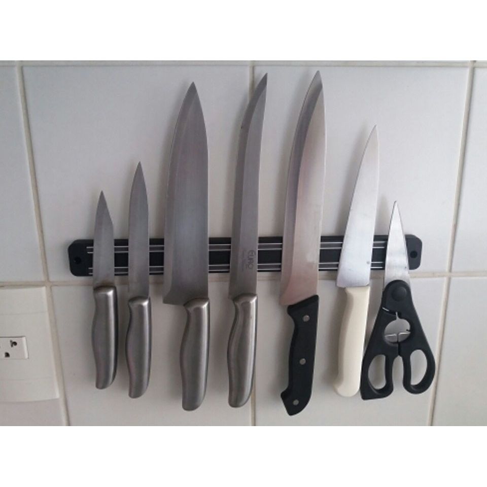 Magnetic knife strip mounted on a kitchen wall