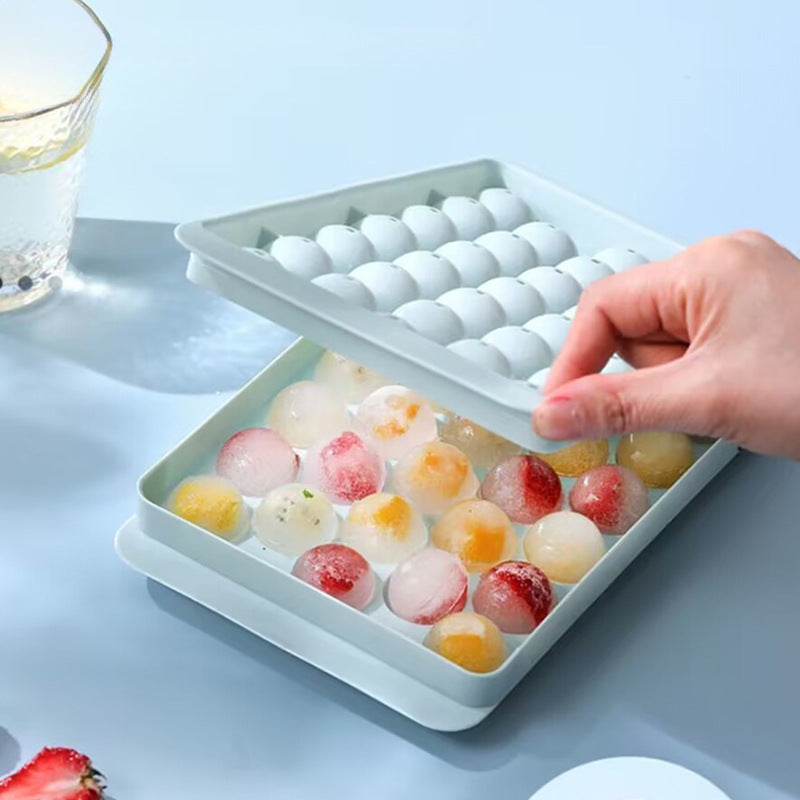 Round ice cubes released from silicone tray
